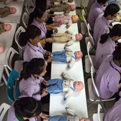A file picture of women training to be a nannies in Beijing using plastic babies during one class. Photo: Getty Images