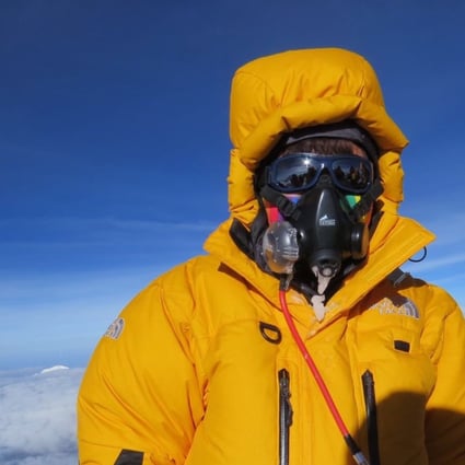 Ada Tsang on the summit with an oxygen mask. Photo: Handout