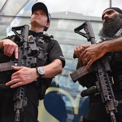 Armed police on patrol in Manchester. Up to 5,000 armed troops can be deployed at transport hubs and other crowded public places in order to release the armed police for other duties. Photo: EPA