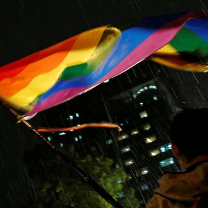 A supporter waves a rainbow flag during a rally after Taiwan’s constitutional court ruled that same-sex couples have the right to legally marry, the first such ruling in Asia, in Taipei on Wednesday. Photo: Reuters