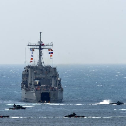A landing ship is surrounded by amphibious assault vehicles during the training exercise. Photo: AFP