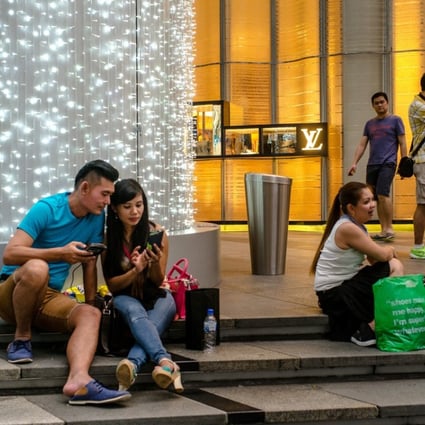 Shoppers on Orchard Road in Singapore. Some experts say the social experience of shopping will help save some brick-and-mortar stores from oblivion in an e-commerce age. Photo: Bloomberg