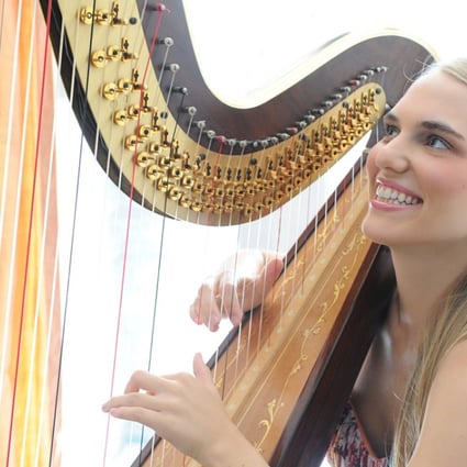 Juliana Beckel plays the harp, which represents the river, in The Beat of the Dragon Boat, a work for a mix of Eastern and Western instruments that celebrates the Tuen Ng (Dragon Boat) Festival and will be performed in two concerts on Sunday.