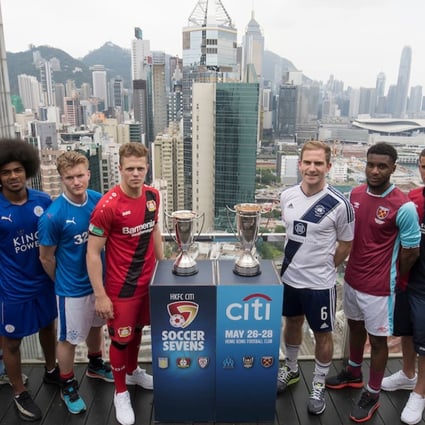 From Left to Right: Olympique Marseille's Lucas Genty, Aston Villa's Harry McKirdy, Leicester City's Hamza Dewan Choudhury, Glasgow Rangers' Max Ambrose, Bayer Leverkusen's Joel Abu Hanna, Causeway Bay's Andrew Wylde, West Ham United's Moses Makasi, Cagliari Calcio's Vasco Oliveira, and playonPROS's Colin Hendry pose for a photograph in front of Hong Kong's urban landscape to celebrate the launch of the HKFC Citi Soccer Sevens 2017 on 25 May 2017 in Causeway Bay, Hong Kong, China. Photo by Chris Wong / Power Sport Images