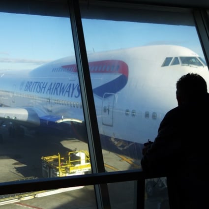 A passenger looks at a British Airways flight at John F. Kennedy (JFK) international airport in New York after a computer systems failure caused chaos for thousands of passengers on a busy holiday weekend. Photo: AFP