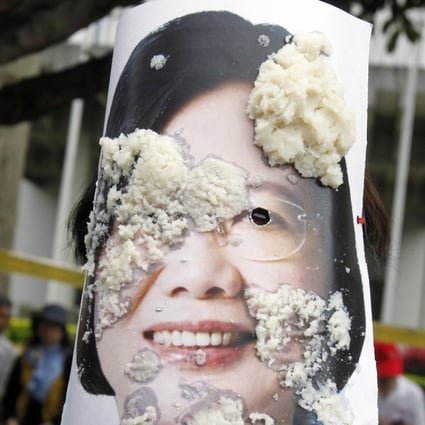 A person wearing a photo of Taiwan's President Tsai Ing-wen is covered by bean curd during a Labour Day rally in Taipei. Beijing has frosty relations with Tsai, suspecting that she wants formal independence for Taiwan.