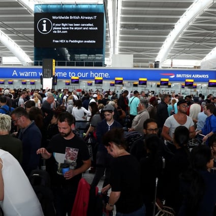 People wait with their luggage at the British Airways check-in desks at Heathrow Terminal 5 in London. Photo: Reuters