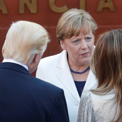 German Chancellor Angela Merkel (centre) talks to USPresident Donald Trump and first lady Melania Trump as they arrive to attend a performance by the La Scala Philharmonic Orchestra in the ancient Greek theatre as part of the G7 Summit in Taormina, Sicily on May 26. Photo: Reuters