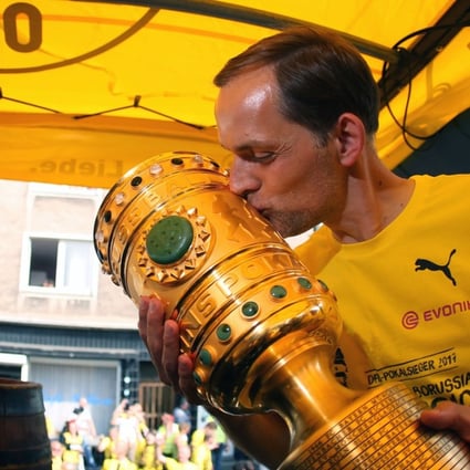 Dortmund coach Thomas Tuchel kisses the trophy at Borsigplatz during celebrations after winning the German Cup. Photo: AFP