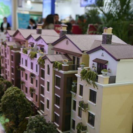 Models of residential buildings are seen during an overseas property exposition in Beijing in April. Prices and transactions of second-hand residential property plunged in May, as the government’s curbs took effect. Photo: Reuters