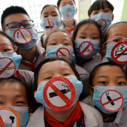 Students wear masks with “No Smoking” signs to support World No Tobacco Day last year, at a primary school in Handan, in the Hebei province of China, the world’s biggest producer and consumer of tobacco products. Photo: AFP