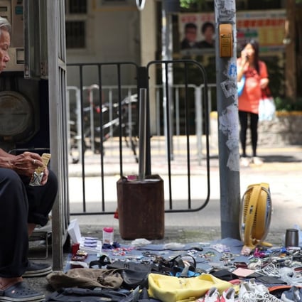 An elderly man sells secondhand goods on a street in Hong Kong’s Sham Shui Po district. Photo: Sam Tsang
