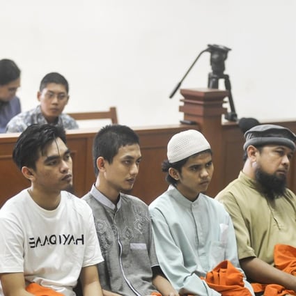 From L-R: Detained Indonesian militants Leonard Hutajulu, Hadi Gusti Yanda, Gigih Rahmat Dewa, Tarmiji, Trio Syafrido, and Eka Saputra attend a hearing at the East Jakarta court in Jakarta. Photo: AFP