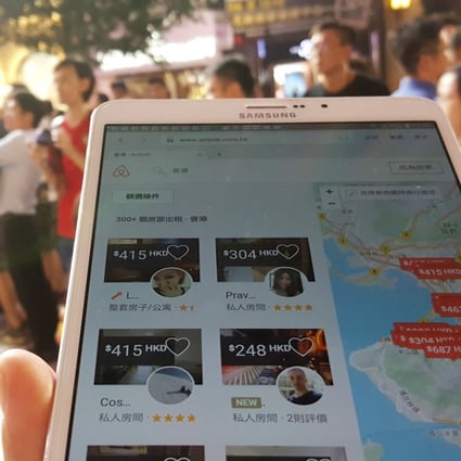 A tourist is checking the Airbnb app with his mobile device in Causeway Bay. Photo: Martin Chan
