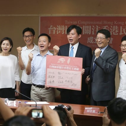 Huang Kuo-chang (fourth from right) with Alex Chow (second left), Eddie Chu (fourth left), Raymond Chan (fifth left), Nathan Law (second right), Joshua Wong (right) and other Taiwanese legislators at the platform launch. Photo: CNA