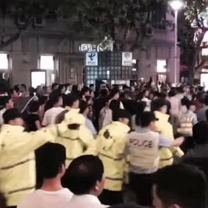 Hundreds of demonstrators marched through a shopping district in Shanghai on Sunday protesting against changes to housing regulations. SHKP has halted sales of converted apartments in the city. Photo: Handout