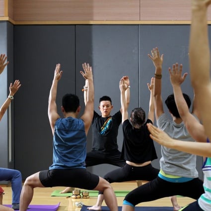 Yoga classes have income a routine for many Hong Kong residents and executives to fend off stress and stay healthy. Photo: Nora Tam