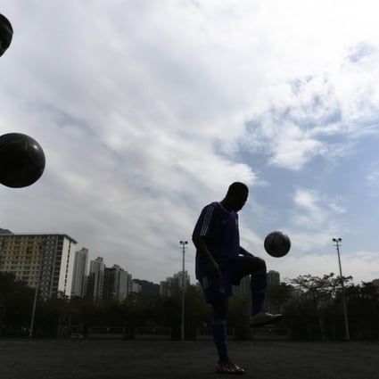 Players from All Black FC, an all-African team made up entirely of refugees and asylum seekers with support from the Chelsea FC Soccer School, practise in Kowloon Bay Park. Photo: Jonathan Wong