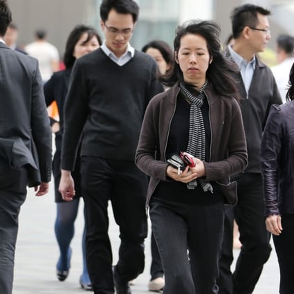 Office workers outside the government headquarters in Hong Kong. Studies in Japan and Canada show that closing the gender participation gap in the workforce could boost annual GDP by up to 13 per cent. Photo: Nora Tam