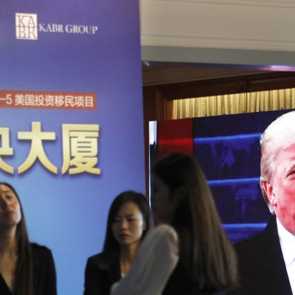 A projector screen shows a footage of US President Donald Trump as workers wait for investors at a reception desk during an event promoting EB-5 investment in a Kushner Companies development, at a hotel in Shanghai, China, on Sunday, May 7, 2017. The company is seeking Chinese investors for a project in New Jersey. Photo: AP