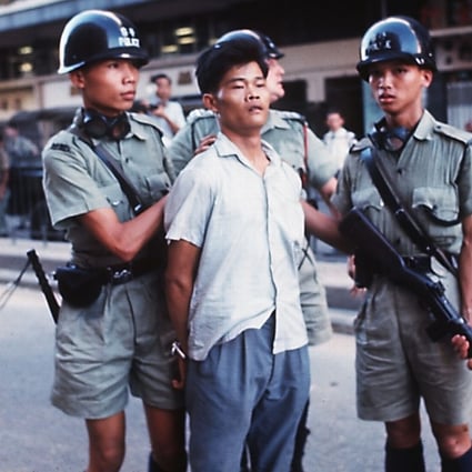 A man is taken into custody by police during the 1967 riots in Hong Kong.