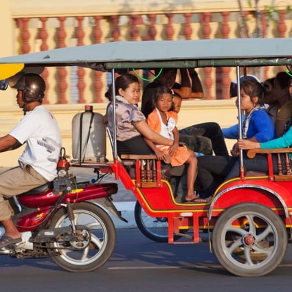 A family travels via tuk-tuk in Phnom Penh, Cambodia. Handout photo