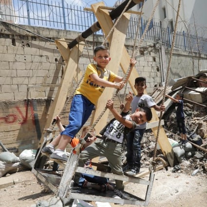 Syrian refugee children play on swings in the Shatila Palestinian refugee camp in the Lebanese capital, Beirut. Photo: AFP