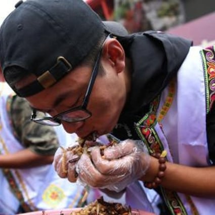 Contestants get stuck in at the insect eating challenge in Lijiang, Yunnan province, on Sunday. Photo: Handout