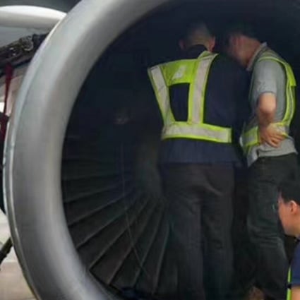 The China Southern Airlines plane engine is searched for the “lucky coins” thrown by an elderly passenger at Shanghai Pudong International Airport. Photo: Handout