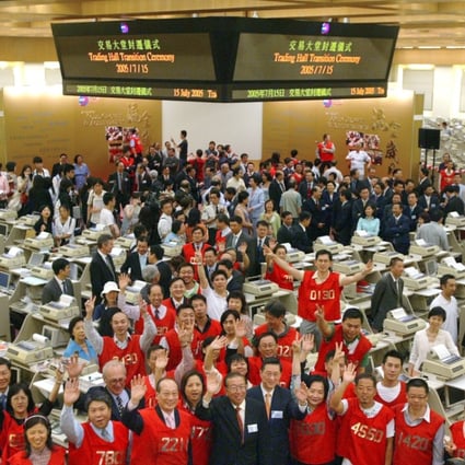 Directors and traders wave goodbye to the media in the ceremony to mark the transition of the Stock Exchange Trading Hall, at Hong Kong Stock Exchange, Central. 15 July 2005. Photo: SCMP