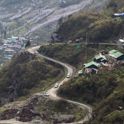 Vehicles travel along a mountain road near the Nathu La Pass, a trading post in the Himalayas between India and China in the state of Sikkim. Photo: Bloomberg