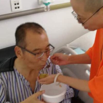 In an undated photo, Chinese dissident Liu Xiaobo is attended to by his wife Liu Xia in a hospital in China. Photo: AP