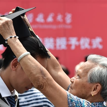 Graduate Xue Jiahong's grandmother adjusts his mortar board during a graduation ceremony at the University of Science and Technology of China in Hefei last month. Photo: Xinhua