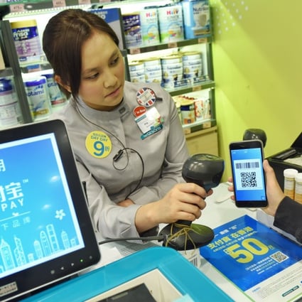 A staff worker tests AlipayHK at a store in Hong Kong. US payments provider Stripe has struck partnerships with Alipay and WeChat Pay. Photo: Xinhua