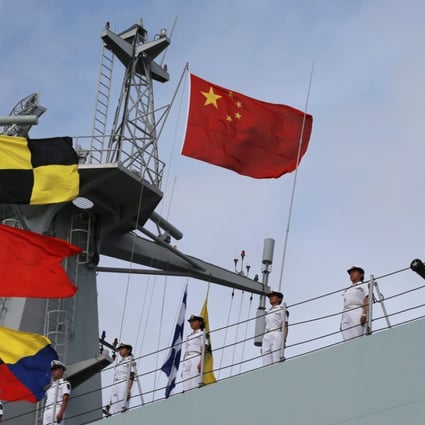 Soldiers of China’s People's Liberation Army stand on a ship sailing off from a military port in Zhanjiang, Guangdong province, on Monday. Photo: Reuters