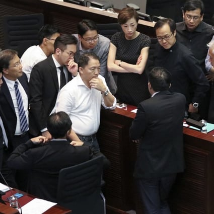 Pan-democrats discuss how to proceed at yesterday’s Legco meeting following the disqualification of four of their lawmakers. Photo: Felix Wong