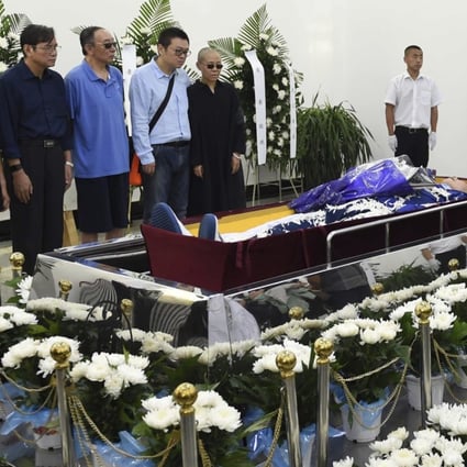 Liu Xia (right), widow of the late dissident Liu Xiaobo, is supported by her brother Liu Hui at the funeral service in Shenyang, Liaoning province on Saturday. Photo: AP