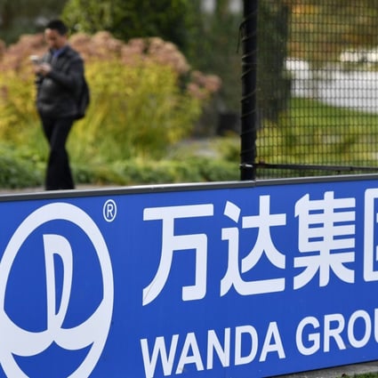 The sign and logo of Wanda Group, a Chinese multinational conglomerate corporation and FIFA partner, is seen on October 13, 2016 at the world football's governing body headquarters in Zurich. More Chinese joined the ranks of the super-rich this year, a survey showed on October 13, 2016, bringing the total to an all-time high despite dragging growth in the world's second-largest economy. Property and entertainment mogul Wang Jianlin, chairman of conglomerate Wanda Group, was tipped the richest man in China with a fortune of USD 32.1 billion, down two percent from a year ago, the survey said. Photo: AFP