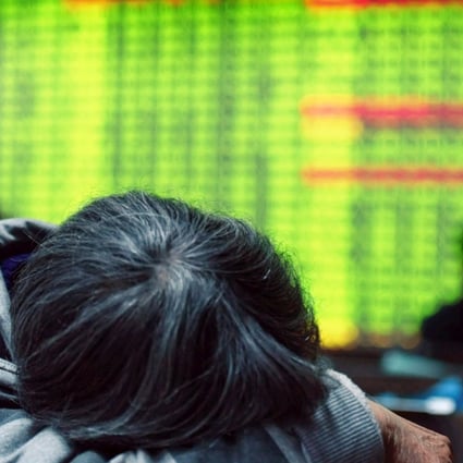 An investor taking a break in front of a screens showing stock market movements at a securities firm in Hangzhou. Contrary to global conventions, China’s stock market denotes positive gains in red, and declines and losses in green.Photo: AFP