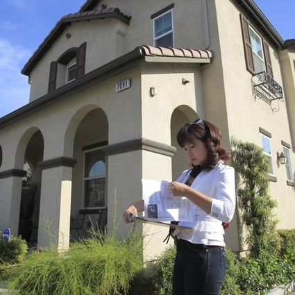 Alisha Chen, an agent in Irvine who specialises in buying houses for Chinese investors, checks her listings while touring homes for sale in Chino, California. Photo: MCT