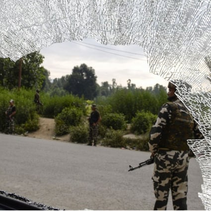Indian paramilitary troopers are seen through the broken windshield of a vehicle at the site of an attack on Hindu pilgrims in Anantnag, south of Srinagar. Photo: AFP