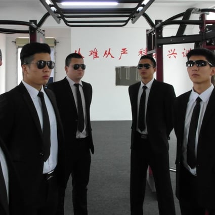 Security guards from Zhongzhou Bodyguard pose in suits and shades in the company gym in Shenzhen. The firm has been looking after China’s business leaders for the past 11 years. Photo: Handout