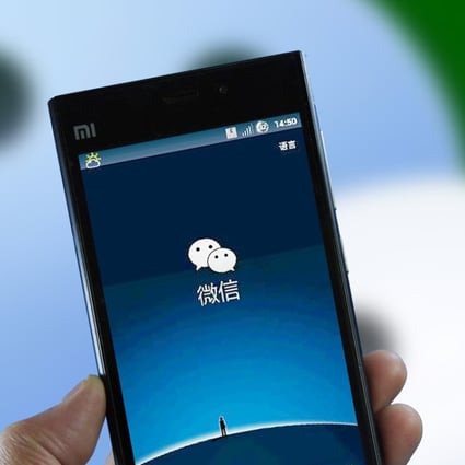 A mobile phone user displays WeChat. Photo Imaginechina