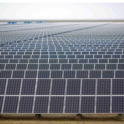 A worker inspects panels at a solar farm in Dunhuang, Gansu Province. The distance between the remote region and the majority of China’s recycling facilities adds to the cost of disposing of the panels once they have reached the end of their useful life. Photo: Reuters