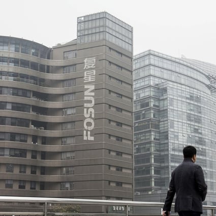 A pedestrian walks across a footbridge in front of the Fosun International Ltd headquarters building in Shanghai, China. The company joined Beijing Sanyuan Foods in buying St Hubert of France for US$733 million, Photo: Bloomberg