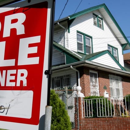 A file photo of a real estate sign in front of a house in Queens, New York. Photo: EPA