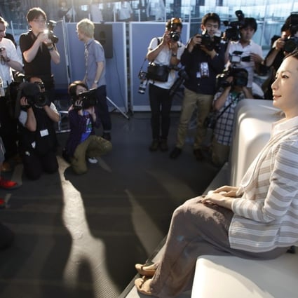 Robot newscasters Kodomoroid and Otonaroid meet the Japanese press in Tokyo. Photo: AP