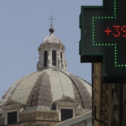 A thermometer displays 39 degrees Celsius (103 Fahrenheit) outside a chemist's shop in Rome. Scientists are warning that weather-related deaths could spike by the end of the century due to climate change. Photo: AP