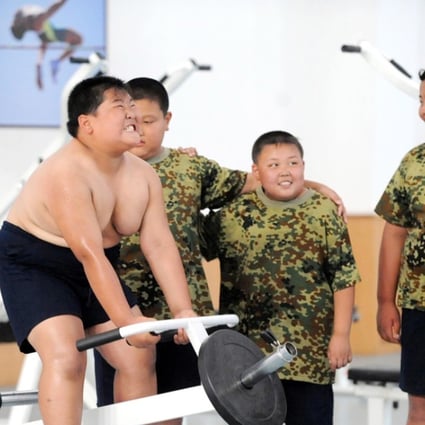Obese Chinese children exercise in a fitness centre during a military training summer camp at the Shenyang Artillery College in Shenyang city, northeast China’s Liaoning province. Photo: Imaginechina