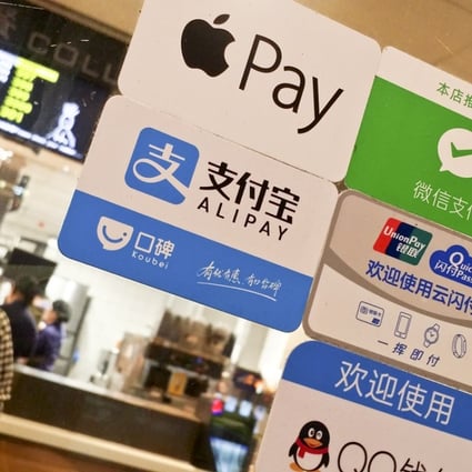 A signboard of payments through Apple Pay, Alibaba’s Alipay, Tencent’s WeChat Pay and QQ Payment, as well as China UnionPay, at a store in Guangzhou. Photo: ImagineChina.